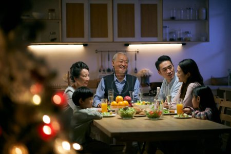 Téléchargez les photos : Trois génération asiatique famille gatthering à la maison avoir dîner célébrer noël - en image libre de droit