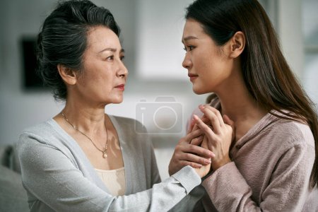 Photo for Young asian adult daughter consoling senior mother living with mental illness - Royalty Free Image