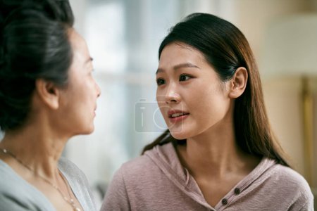 Photo for Young asian adult daughter consoling senior mother living with mental illness - Royalty Free Image