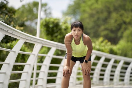 Photo for Young asian woman female jogger getting ready to run outdoors - Royalty Free Image