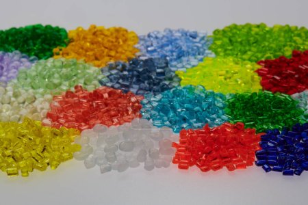 Variation of different colored plastic resin granulates 