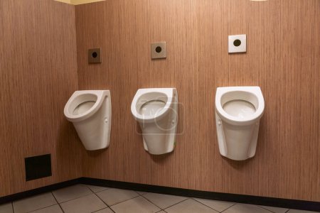 Photo for Urinals in an old building for men only - Royalty Free Image