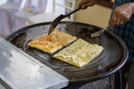 Photo for Making process of Martabak Telor. Savoury pan-fried pastry stuffed with egg, meat and spices - Royalty Free Image