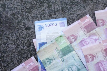 Indonesian money is neatly lined up with various denominations