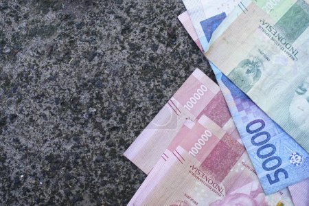 Indonesian money is neatly lined up with various denominations