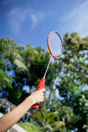 playing badminton outdoors during the day