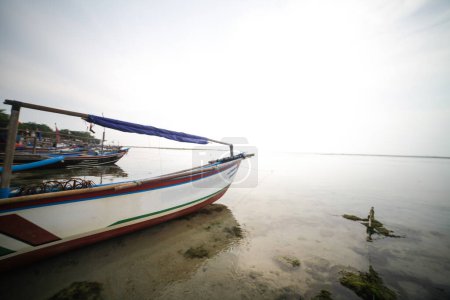 Photo for Boat leaning on the beach of Ujung Genteng sukabumi Indonesia - Royalty Free Image