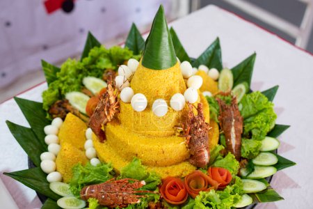 Nasi tumpeng with various decorations for birthday celebrations