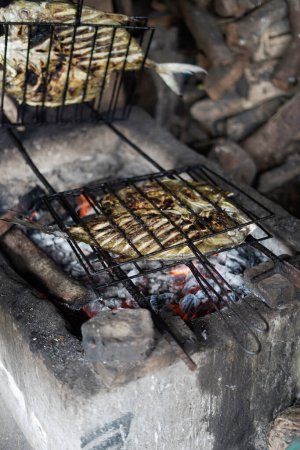 Fish is grilled on medium heat so that it cooks evenly