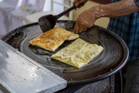 Making process of Martabak Telor. Savoury pan-fried pastry stuffed with egg, meat and spices