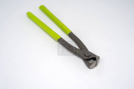 Black iron cutting tongs with green handle isolated on white background
