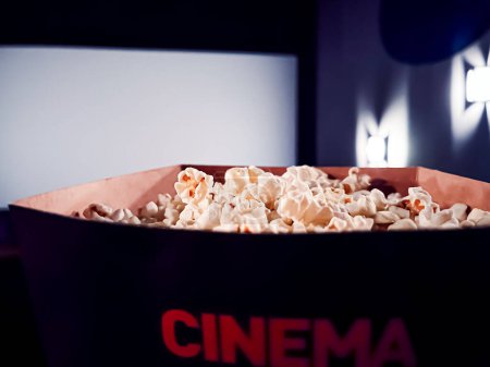 Photo for Cinema and entertainment, popcorn box in the movie theatre for tv show streaming service and film industry production branding - Royalty Free Image