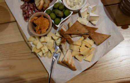 Photo for Cheese plate on wooden table, for a friendly party in a bar or restaurant. - Royalty Free Image
