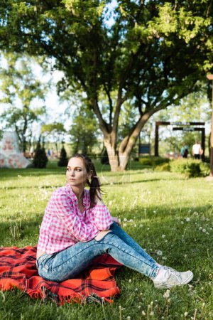 Photo for Portrait of a beautiful smiling woman relaxing in nature on a warm sunny day - Royalty Free Image