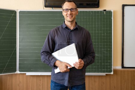 Photo for Portrait of a confident Caucasian male teacher in class - Royalty Free Image