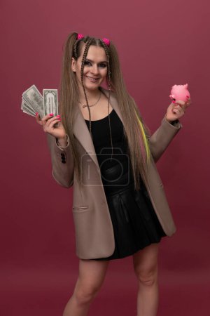 Photo for Woman saving money in a piggybank - Royalty Free Image