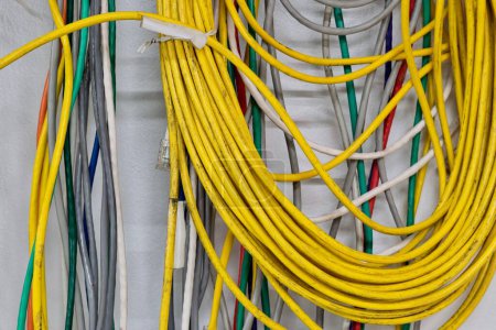 Foto de Coloridos cables eléctricos viejos que cuelgan de una pared. CAT5 Cables par trenzado para redes informáticas. - Imagen libre de derechos
