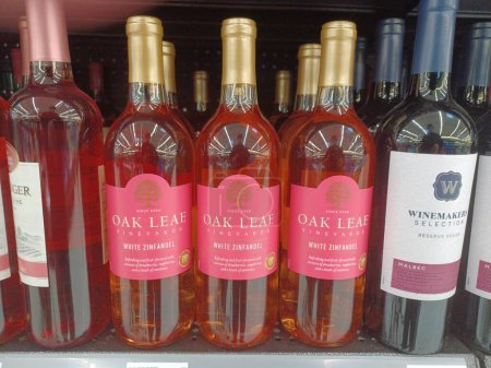 Photo for Houston, Texas USA 10-27-2022: White Zinfandel and Malbec wine bottles isolated on display on a supermarket shelf. Oak Leaf Vineyards and Winemakers Selection brand names displayed. - Royalty Free Image