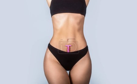 Epilation concepts. Slim woman with perfect body in panties holds razor. Shaving machine in panties. Girl health and intimate hygiene. Beautiful womans body with smooth soft skin in bikini panties.