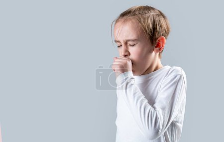 Boy coughing sick colds sneezing cough. Child got sick with a virus. Children coughs. Child is ill, he coughs. Treatment of colds and flu. Covid-19.