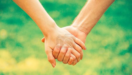 Photo for Hold on, hands, couples. Couple hold hand in the autumn or summer park. Closeup of loving couples holding hands while walking. - Royalty Free Image