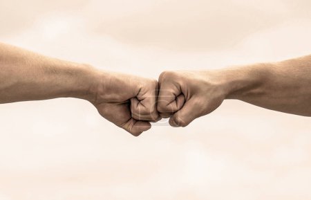 Concept of confrontation, competition. Gesture of giving respect or approval. Teamwork and friendship. Partnership concept. Man giving fist bump.
