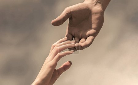 Lending a helping hand. Hands of man and woman reaching to each other, support. Solidarity, compassion, and charity, rescue.
