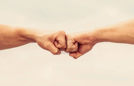 Photo for Teamwork and friendship. Partnership concept. Man giving fist bump. Bumping fists together. Fist Bump. Clash of two fists. Concept of confrontation, competition. - Royalty Free Image