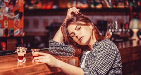 Photo for Alcohol abuse and alcoholic concept. Drunk woman holding a glass of whisky or rum. Woman in depression. Young beautiful woman drinking alcohol. - Royalty Free Image