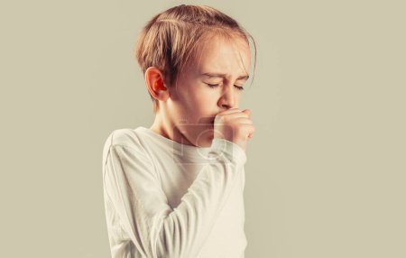 Boy coughing sick colds sneezing cough. Child got sick with a virus. Disease concept. A sick boy child coughs. Child is ill, he coughs. Treatment of colds and flu.