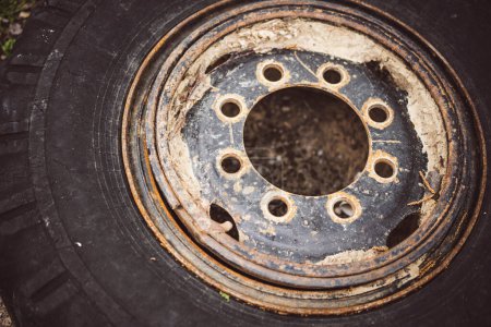 Photo for Detail of the used wheel of a truck, with a rusty rim and worn out tire. - Royalty Free Image