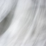 Abstract gray-black-white background with defocused waves, lights and shadow. Backdrop