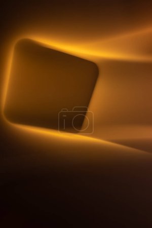 Photo for Abstract glowing square with smooth lines in yellow-orange colors on a black background. Vertical orientation, design element. Copy space - Royalty Free Image