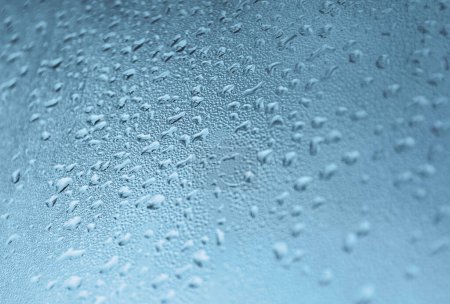 Photo for Close-up of a surface covered with water droplets. The droplets vary in size and create a textured, cool-toned pattern that conveys a sense of freshness and moisture. - Royalty Free Image