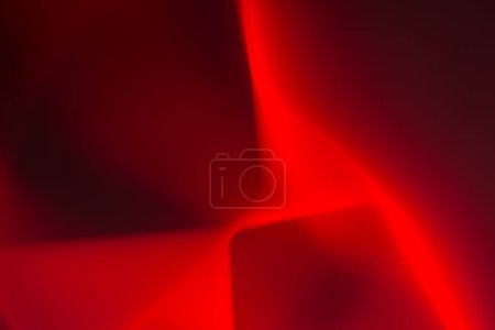 Abstract image with predominant red and dark red colors. It seems as if the smooth transitions of light and shadow create a soft illusion of movement or wavering fabric. Lighter nuances add depth and mystery.