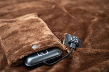 Photo for Electric blanket with portable charger as a power supply at horizontal composition - Royalty Free Image