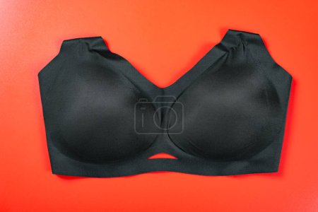 Photo for A black bra on red background - Royalty Free Image