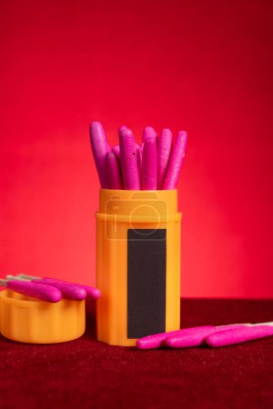 box of windproof and waterproof match sticks on red background at vertical composition