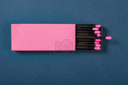 top view pink matchbox on a blue background