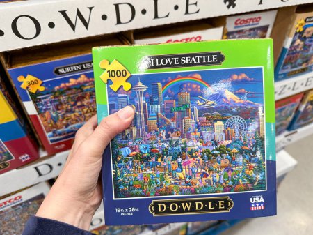 Photo for Maple Grove, Minnesota - November 4, 2022: Hand holds up a Dowdle puzzle at a Costco store. I Love Seattle shown - Royalty Free Image