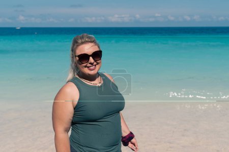 Photo for Woman poses for a photo at a tropical beach in Zanzibar, Tanzania along the Indian Ocean - Royalty Free Image
