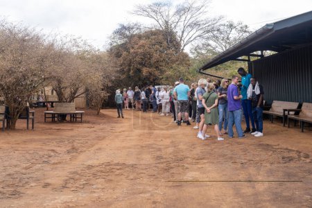 Photo for Nairobi, Kenya - March 17, 2023: Tourists wait in line at Sheldrick Wildlife Trust that raises orphaned elephants, to see the daily milk feeding for the baby elephants - Royalty Free Image