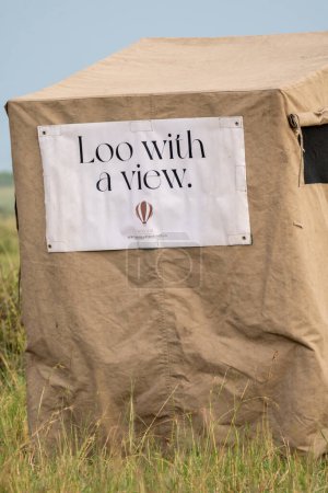 Photo for Kenya, Africa - March 10, 2023: Loo with a view, a makeshift outdoor toilet set up after a hot air balloon ride at breakfast in the African bush of the Masai Mara - Royalty Free Image
