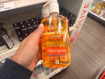 Photo for Plymouth, Minnesota - July 30, 2023: Hand holds a package Neutrogena Oil Free Acne Wash for face care to treat acne - Royalty Free Image