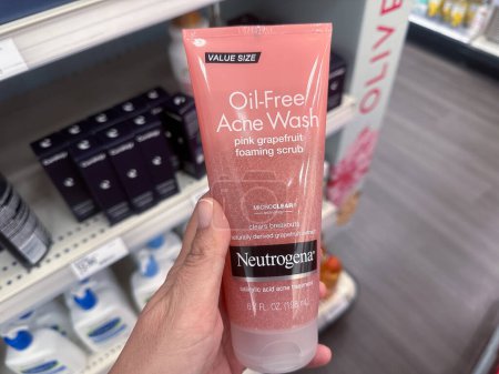 Photo for Plymouth, Minnesota - July 30, 2023: Hand holds a package of Neutrogena Pink Grapefruit Oil Free Acne face wash on sale at a Target store - Royalty Free Image