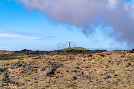 Photo for Incredible summer view of Reykjanes Lighthouse with steam from a Gunnuhver Hot Springs - Royalty Free Image