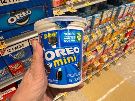 Photo for Dunn Loring, Virginia - November 22, 2023: Hand holds up a container of Oreo Minis to-go pack at a grocery store - Royalty Free Image