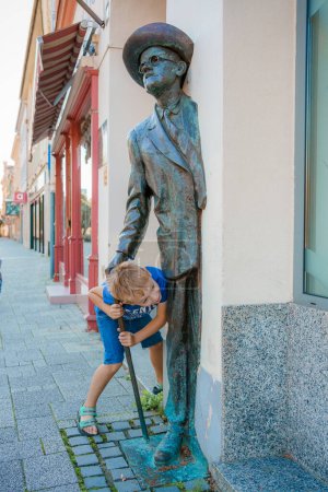 Foto de Niño correr y jugar en la calle en Szombathely en Hungría. Viajar a Szombathely city, Hungría. Europa. - Imagen libre de derechos