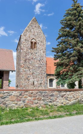 Romanesque village church made of field stones with a wall in Gohre, Saxony-Anhalt, Germany