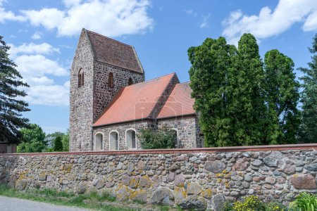 Romanesque village church made of field stones with a wall in Gohre, Saxony-Anhalt, Germany